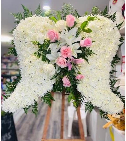 WINGS EMBRACE. An arrangement by Geni's Florist and Gifts.