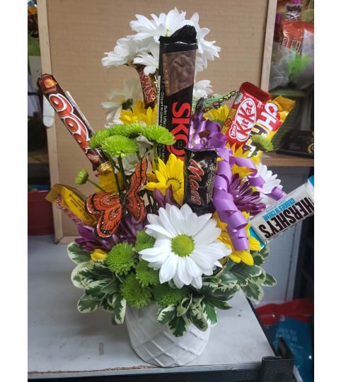 Chocolates and daisies. An arrangement by Jane's Floral Dreams.