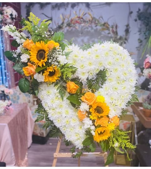 SUNRISE HEART SYMPATHY. An arrangement by Geni's Florist and Gifts.