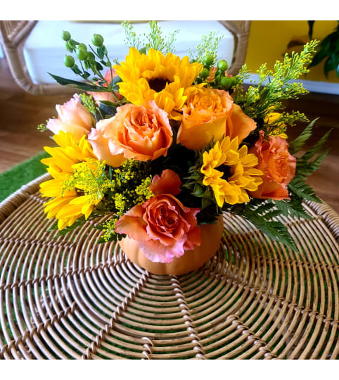 vibrant pumpkin sunshine. An arrangement by Sunshine Flowers.