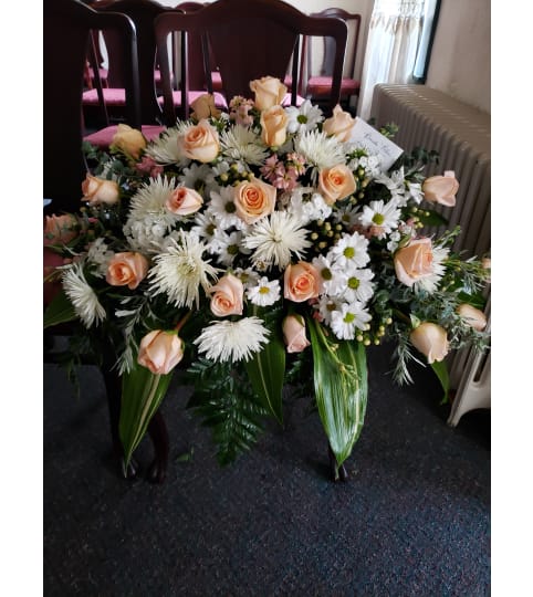 Peaches and Cream Casket Spray. An arrangement by Flowers By Fiore.