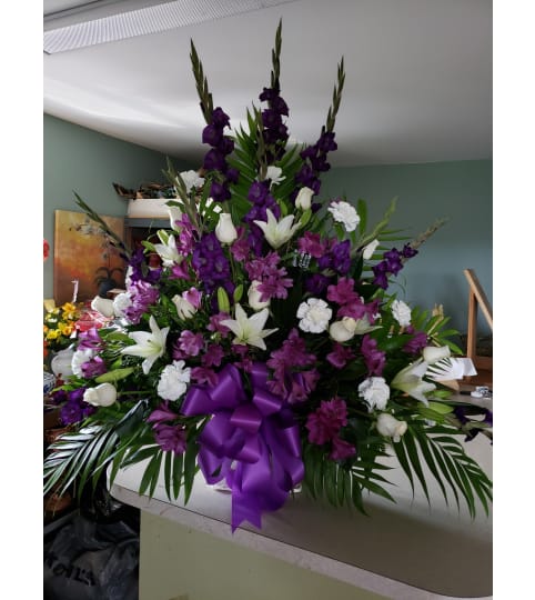 Passionate Purple Tribute. An arrangement by Flowers By Fiore.