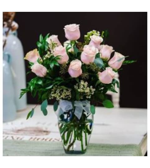 12 Premium pink roses in a vase. An arrangement by Loyalist Flowers.