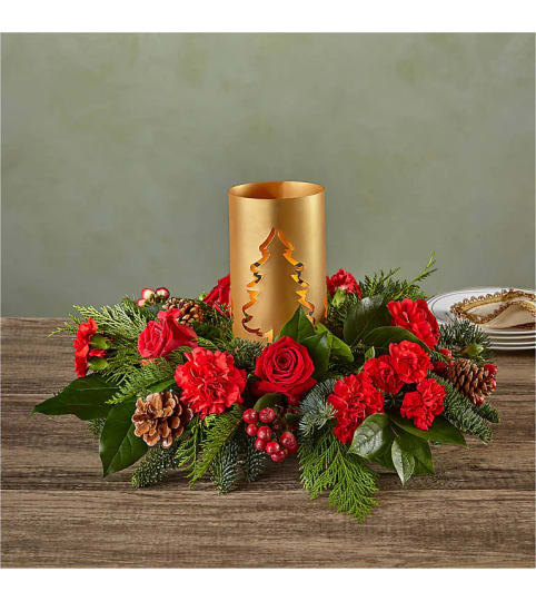 EVERGREEN GLOWING CENTERPIECE. An arrangement by J.D. Ballantine's Flowers and Gifts.