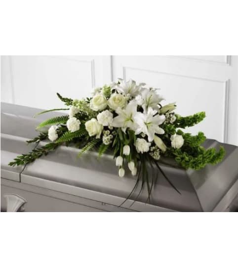White Resurrection Casket. An arrangement by Geni's Florist and Gifts.