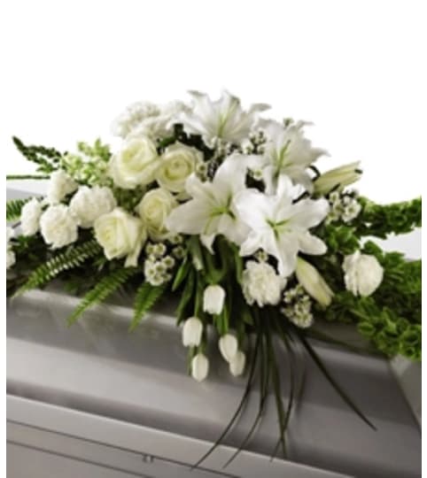 WHITE CLOUD CASKET SPRAY. An arrangement by Brasco Florist.