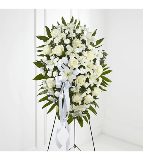 WHITE CLOUD STANDING SPRAY. An arrangement by Brasco Florist.