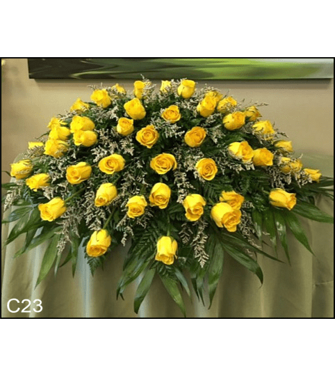 SUNSHINE CASKET SPRAY. An arrangement by Brasco Florist.