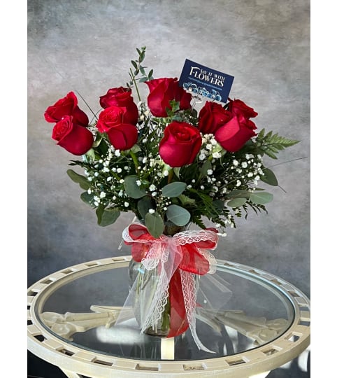 Classic look with 12 red roses. An arrangement by Say It With Flowers.