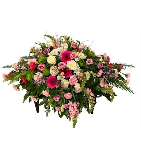 Soft with a pop of colour casket spray. An arrangement by Loyalist Flowers.