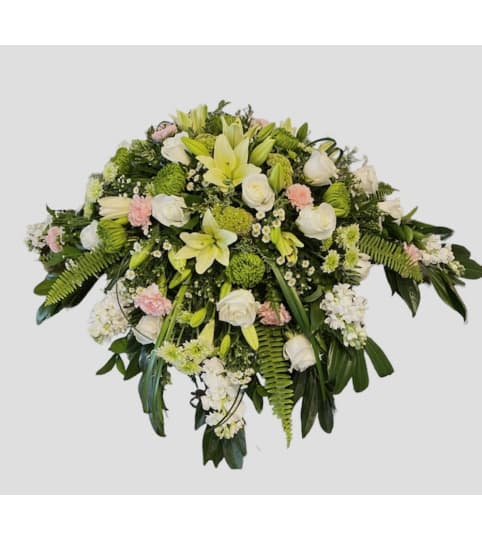 Soft Lily Casket Spray. An arrangement by Loyalist Flowers.