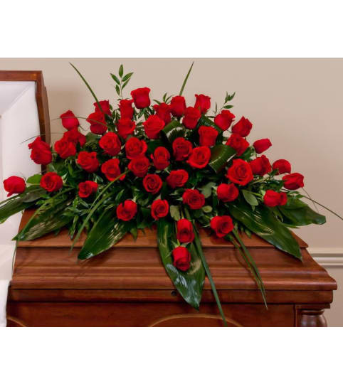 Clasic Red Roses Casket Spray. An arrangement by Garden Florist.