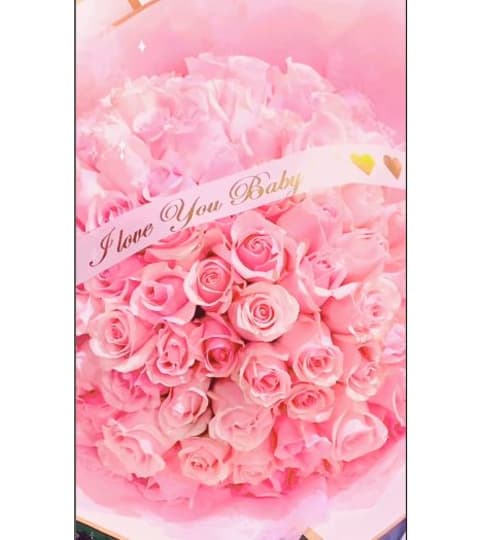 Buchon Roses Wrapped. An arrangement by Geni's Florist and Gifts.