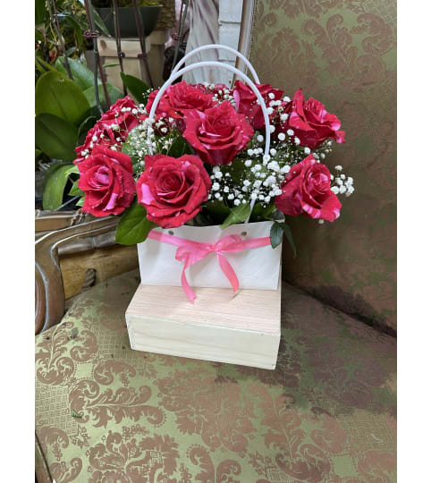 Her Handbag. An arrangement by Rose Flowers.