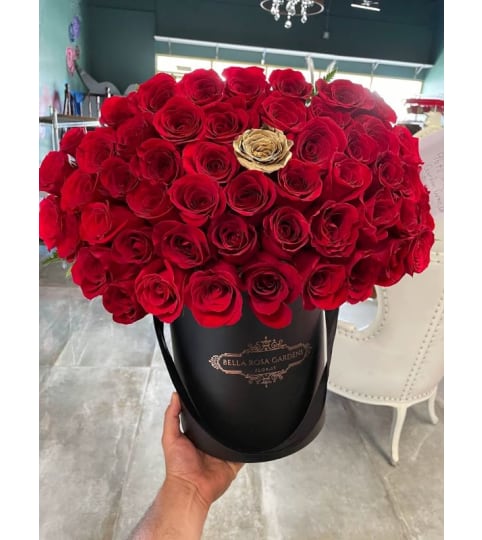 50 RED ROSES WITH GOLD ROSE CENTER. An arrangement by BellaRosa Gardens.