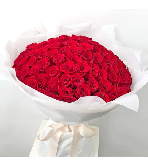 One Hundred Long Stem Premium Red Roses With Greenery Wrapped
