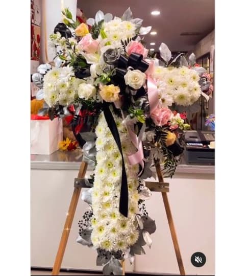 Peace be With You- Standing Cross. An arrangement by Geni's Florist and Gifts.