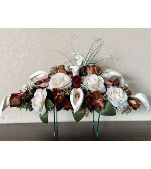 Bronze Tombstone Saddle. An arrangement by Loyalist Flowers.