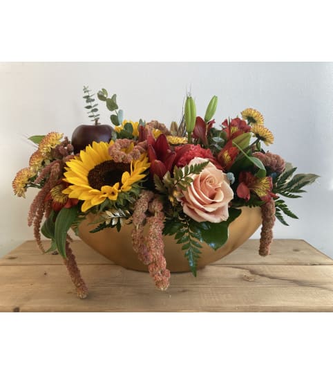 Harvest Warmth Centerpiece. An arrangement by Mayfield Flowers.