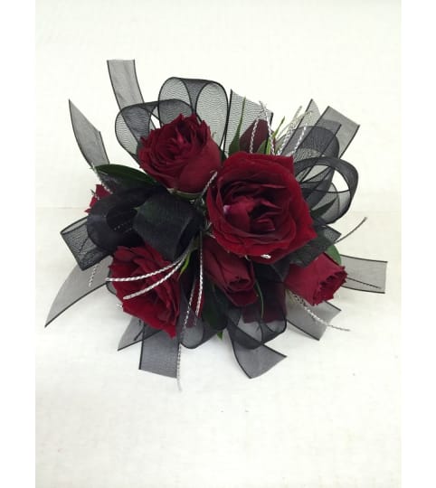 Red Rose Wrist Corsage. An arrangement by Petal Pushers Flower and Gift Shop.