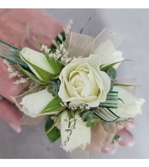 White Rose Wrist Corsage. An arrangement by Petal Pushers Flower and Gift Shop.