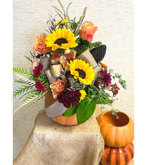 Fall filled Pumpkin. An arrangement by Sussex County Florist.