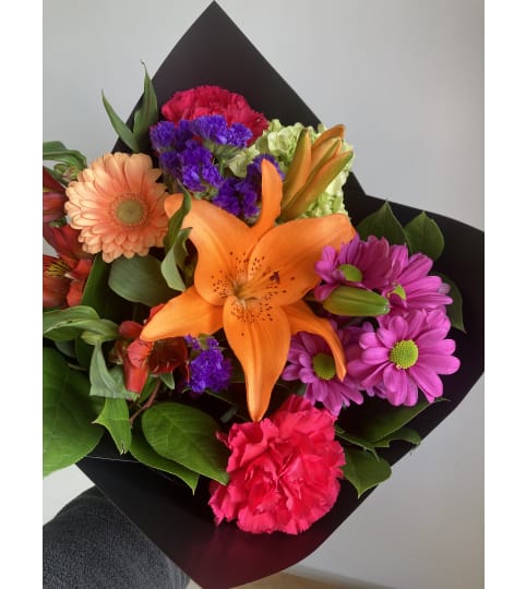 Designer's Vibrant Handtied Bouquet. An arrangement by Mayfield Flowers.