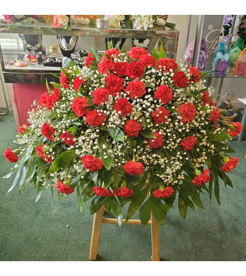 Fresh Red Carnation Casket Spray. An arrangement by Ebony's Flowers and Gifts.
