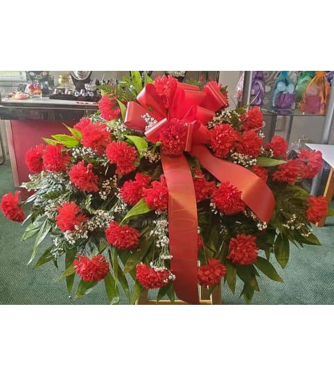 Red Silk Carnation Casket Spray. An arrangement by Ebony's Flowers and Gifts.