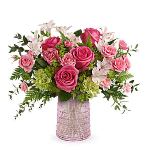 Teleflora Sparkling Joy Carafe Arrangement. An arrangement by Nicol Florist.