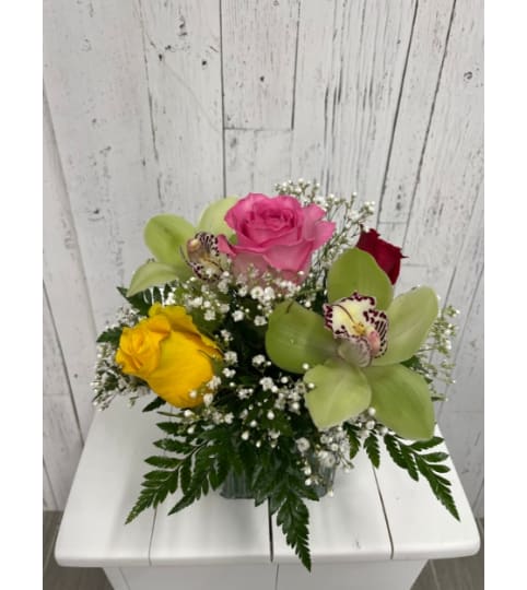 Orchids and Roses (RR). An arrangement by Red Rose Incredible Florist.