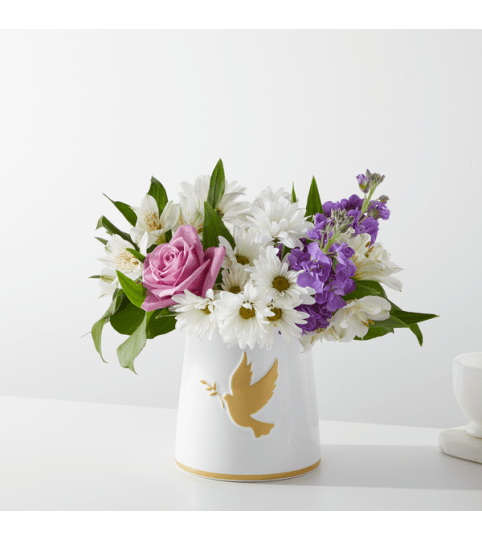 Garden of Peach by FTD. An arrangement by North Liberty Flower Shop.