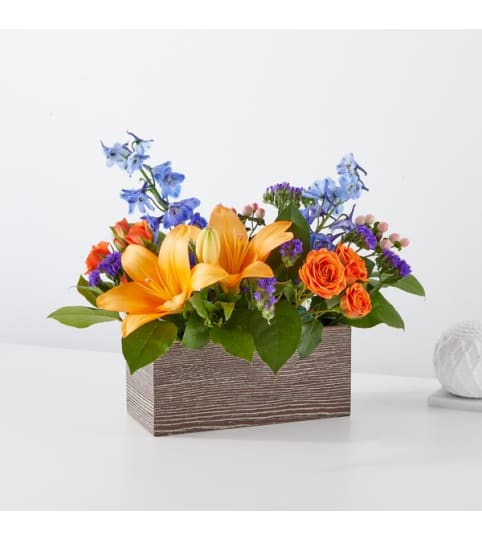 Radiant Citrus Box. An arrangement by North Liberty Flower Shop.