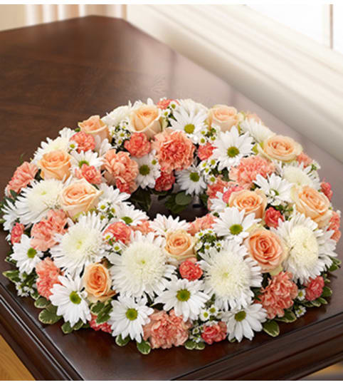 Cremation Wreath - Peach, Orange and White. An arrangement by Graceland Florist.