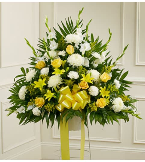 Heartfelt Sympathies Yellow Basket. An arrangement by Graceland Florist.