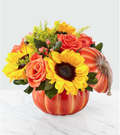 Bountiful Bouquet in a Ceramic Pumpkin. An arrangement by Country Cousins Flower Shop.