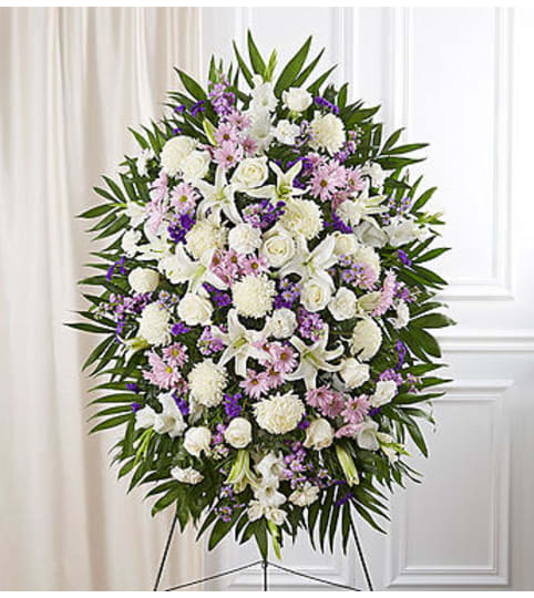 Lavender and White Sympathy Standing Spray. An arrangement by Graceland Florist.