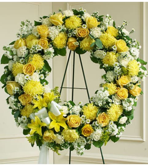 Yellow and White Standing Wreath. An arrangement by Graceland Florist.