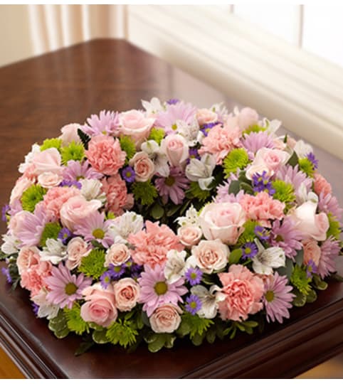 Cremation Wreath - Multicolor Pastel. An arrangement by Graceland Florist.