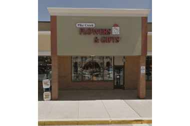 Pike Creek Flower & Gift Shoppe florist arranging flowers