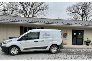 The Barefoot Florist florist arranging flowers