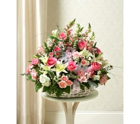 Three- Sided arrangement of Assorted pink flowers in basket .