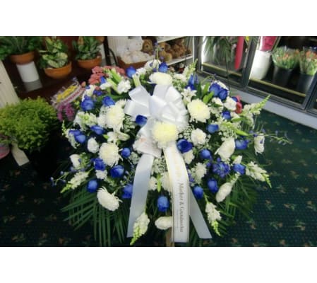blue and white casket cover with blue roses