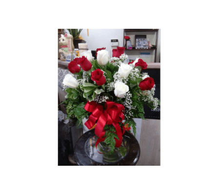 Red and white rose in clear vase by Vivian