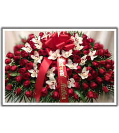 casket cover. An arrangement by Jerome Florist.