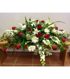 LOVING RED AND WHITE CASKET. An arrangement by Heavenly Flowers.