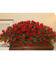 Forever In Our Hearts Casket Cover. An arrangement by Heavenly Flowers.