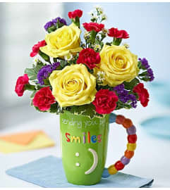 Smiling Mug. An arrangement by Lynette's Flowers and Gifts.