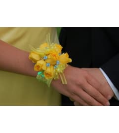 WRIST CORSAGE OF YELLOW ROSES. An arrangement by Flowers by Priscilla.
