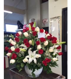 4 doz red and white roses. An arrangement by Commerce Flowers.